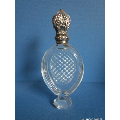 an antique crystal perfume bottle with silver top   