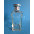 an antique crystal scent bottle with silver top