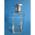 an antique crystal scent bottle with silver top