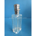 an antique crystal perfume bottle with silver top