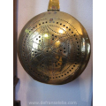 an antique Dutch brass bed warming pan