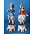 a pair of antique German polychrome porcelain figures