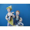 an antique German porcelain couple on a gilt bronze stand