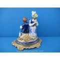 an antique German porcelain couple on a gilt bronze stand