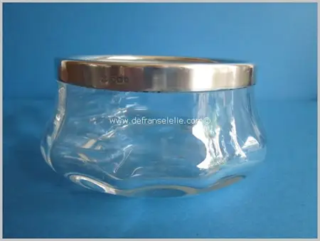 a clear crystal glass bowl with silver mountings