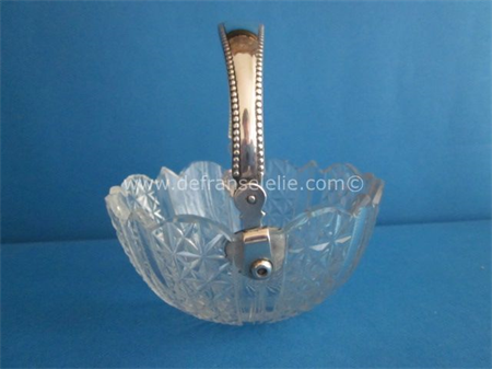 an antique crystal bonbon dish with silver handle