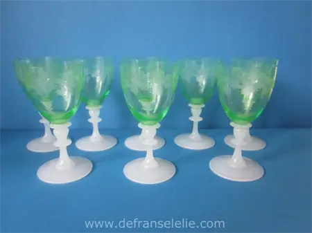a set of eight etched antique green crystal wine glasses