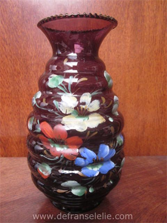an antique hand painted purple glass vase