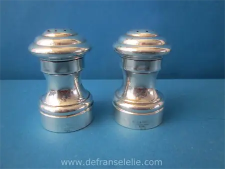 a pair of sterling silver pepper and salt shakers