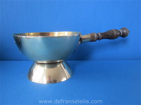 an antique brass handled pan