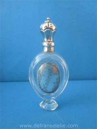 an antique Dutch glass perfume bottle with silver top