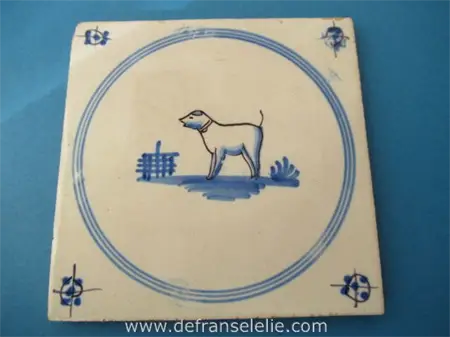 an antique Dutch Delft tile dog