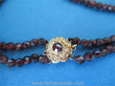an antique garnet necklace with 14ct gold closure