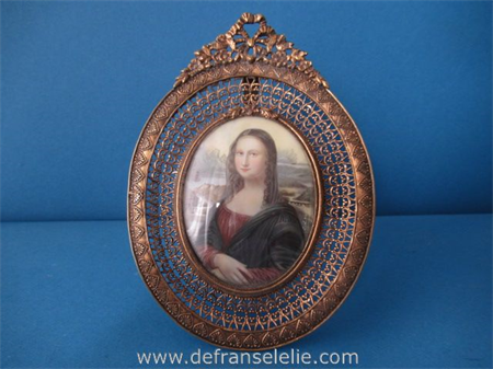 an antique miniature watercolor painting in brass frame