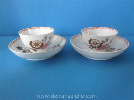 a pair of antique Lowestoft porcelain cups and saucers